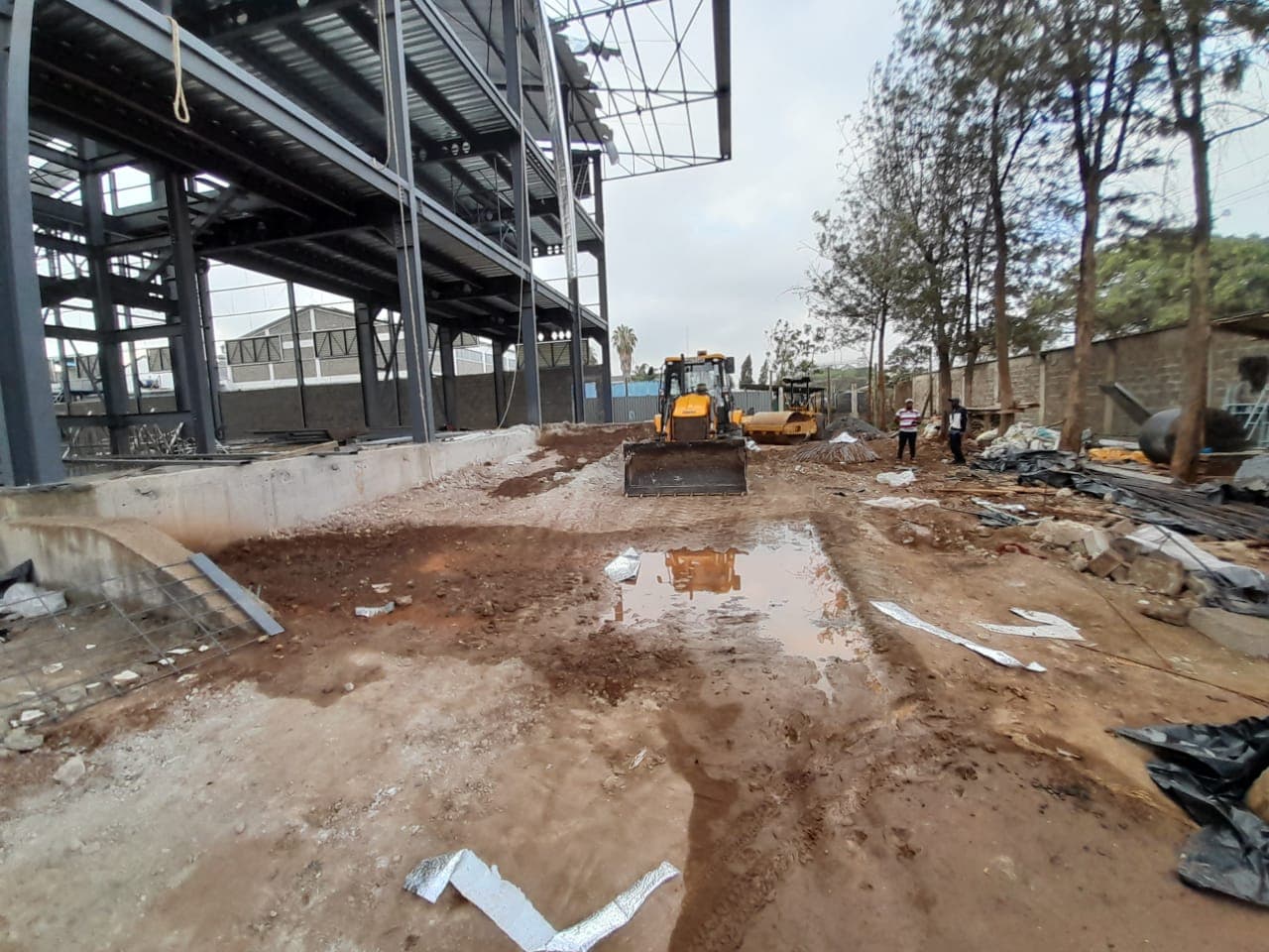 Construction plant working beside a steel structure at a Dunhill site